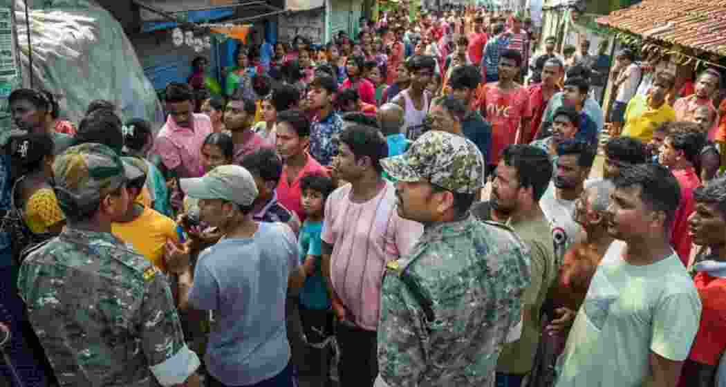 Security personnel control the crowd amid unrest during repolling in South 24 Parganas. 