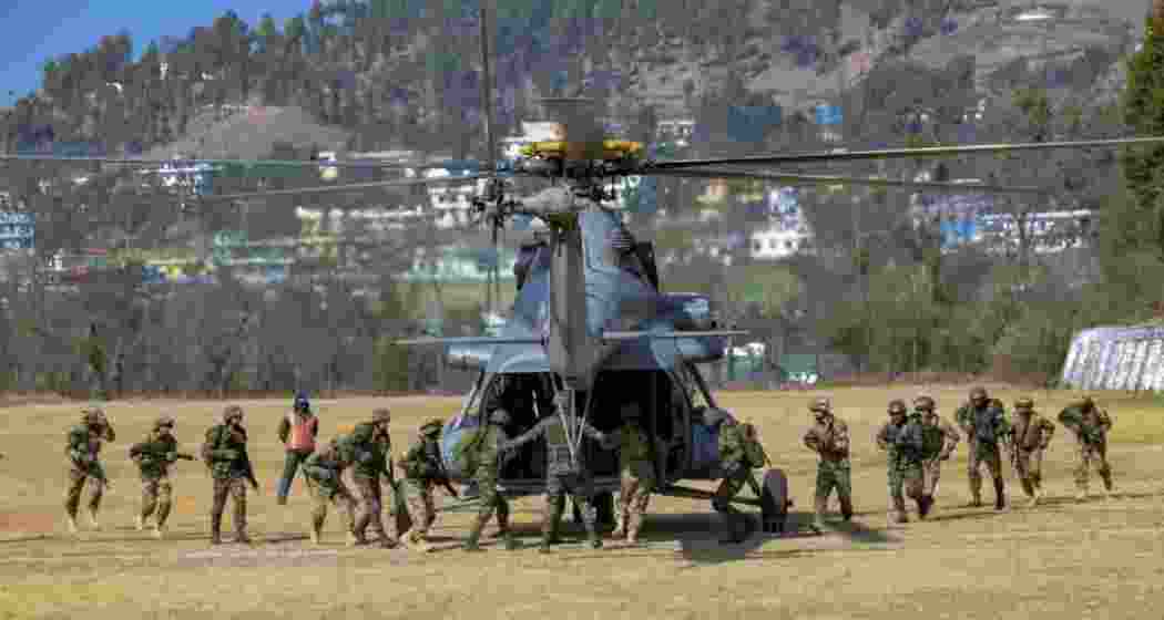 Indian Army and Indian Air Force personnel perform a task during a joint military exercise in the Eastern Sector.