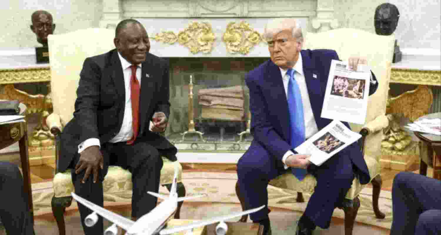 U.S. President Donald Trump (right) holds up a printed article while accusing South African President Cyril Ramaphosa of state-sanctioned violence against white farmers in South Africa during a meeting at the White House in Washington on May 21.