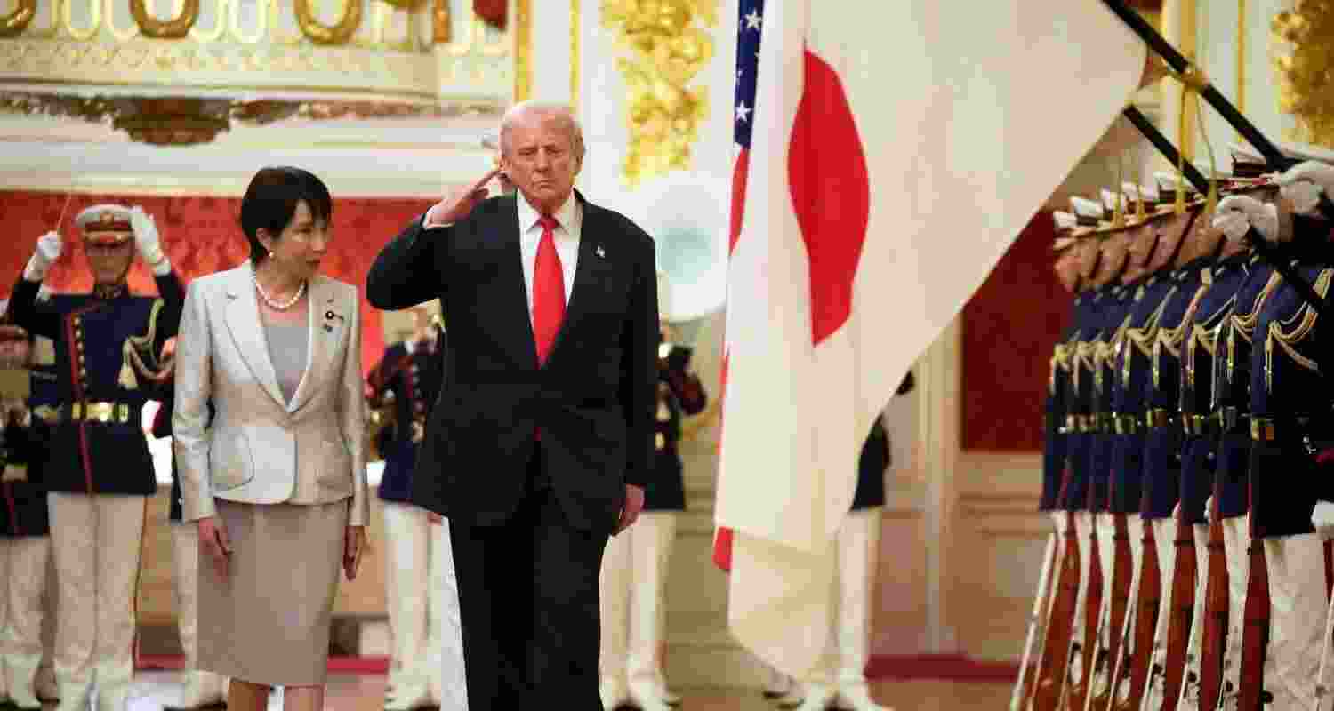 President Donald Trump, center, reviews an honour guard, escorted by Japan's Prime Minister Sanae Takaichi on his arrival at Akasaka Palace in Tokyo, Japan, Tuesday.
