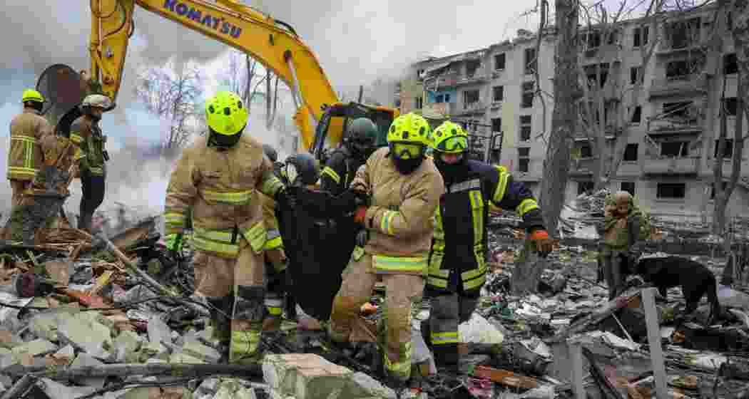 Emergency workers removing the body of a victim from the site of an overnight strike on an apartment building in Kharkiv, Ukraine, on Saturday.
