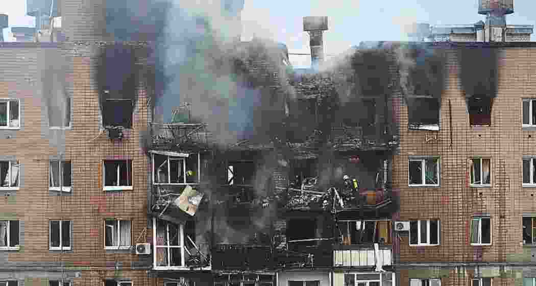 Firefighters struggle to extinguish a blaze from a missile strike Monday on a tire-fitting plant in Lviv in western Ukraine. At least seven people were killed in missile strikes on the city. 