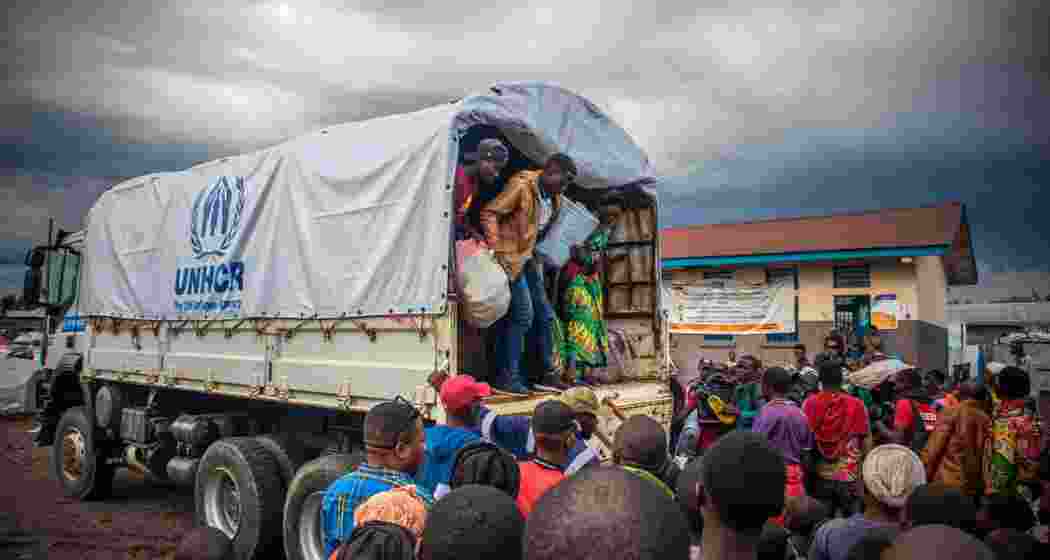 Displaced people get off a UNHCR truck in Kanyaruchinya, Democratic Republic of Congo.