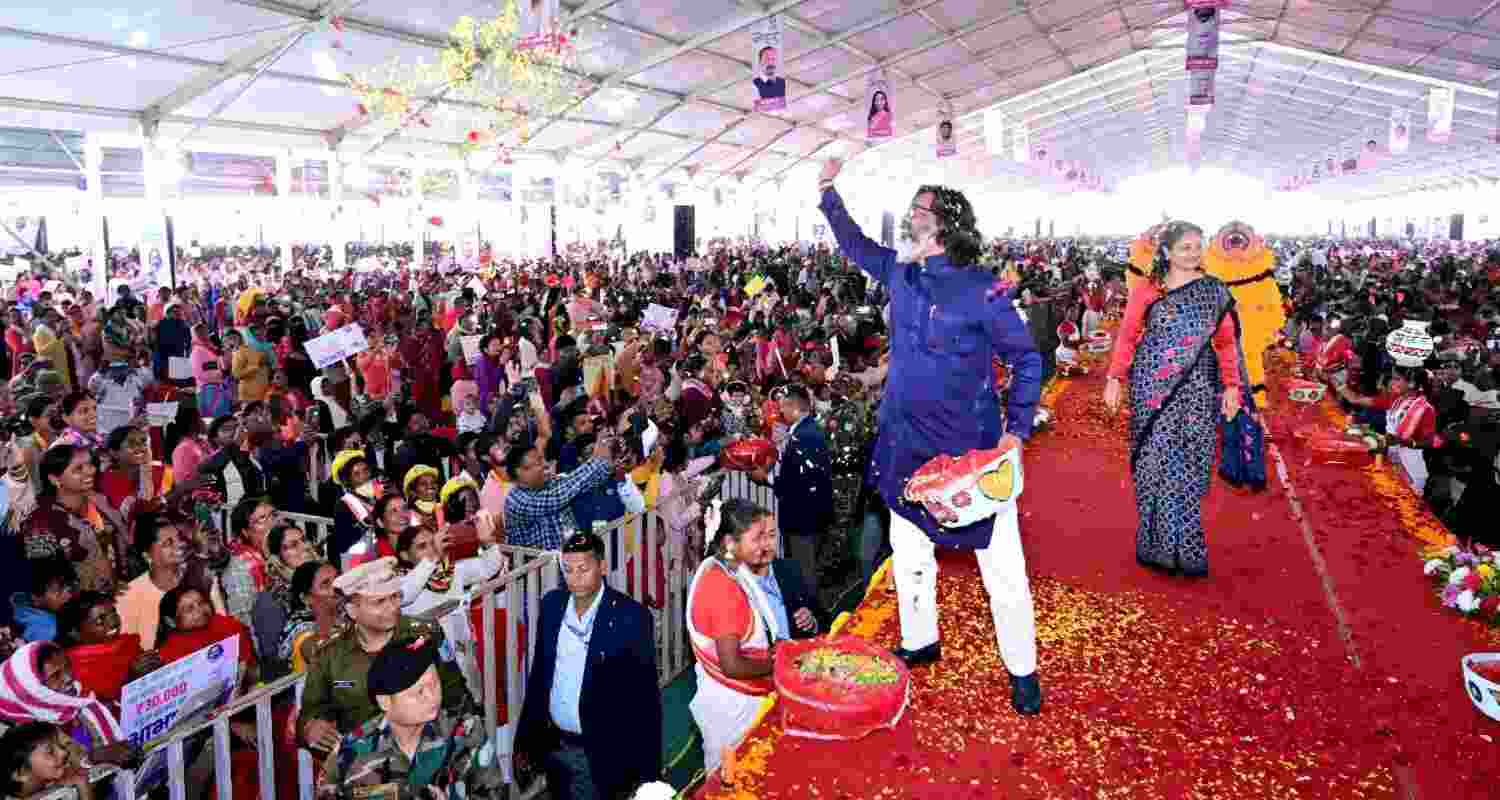 Jharkhand Chief Minister Hemant Soren along with his wife and MLA Kalpana Murmu Soren showers flowers on the beneficiary women during a programme of honorarium distribution of JMMSY in Ranchi on Monday.