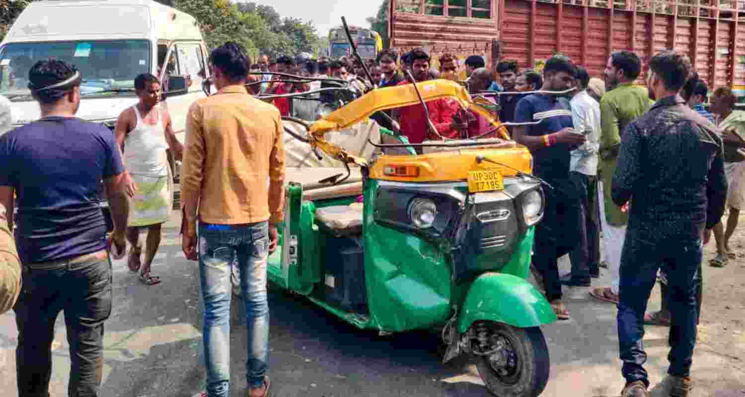 People gather after a collision between a truck and an autorickshaw, leaving 10 people dead, in Hardoi, Uttar Pradesh, Wednesday, Nov. 6, 2024.