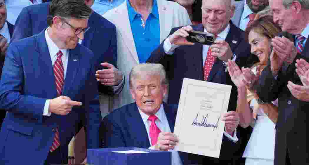 US President Donald Trump displays the signed bill during a ceremony for the One Big Beautiful Bill Act on the South Lawn of the White House in Washington on July 4.