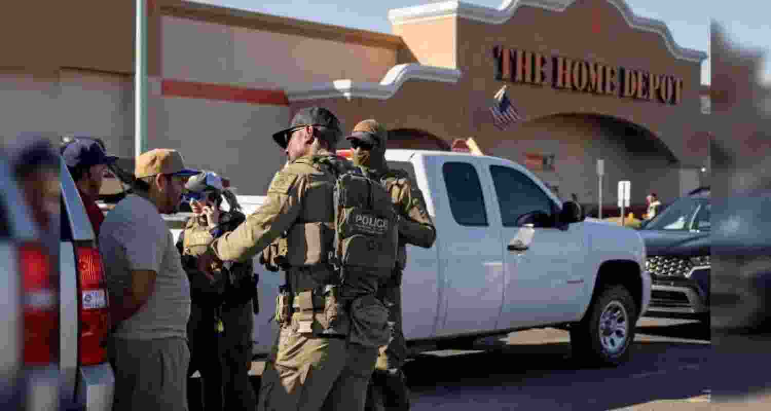 A representative image of ICE agents detain two documented immigrants with prior convictions.