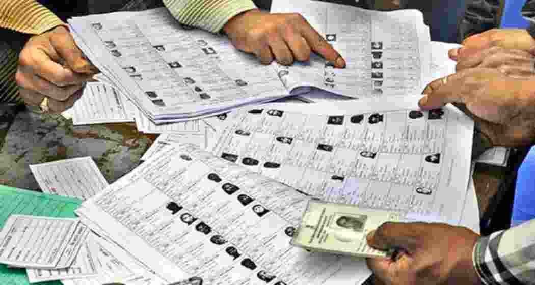 Election staff in Bihar verify voter details during the ongoing roll revision exercise.