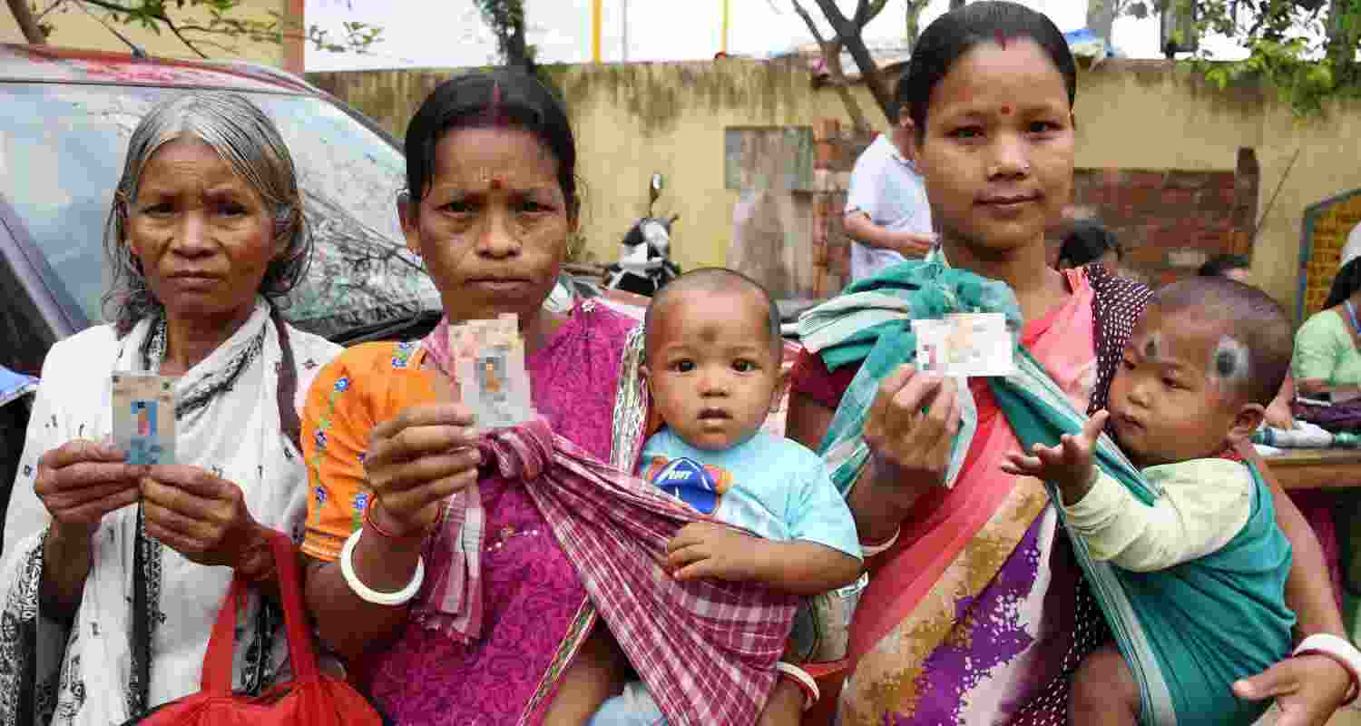 Women show their credentials during the Assam Assembly elections, at a polling station, in Guwahati, Thursday, April 9, 2026.