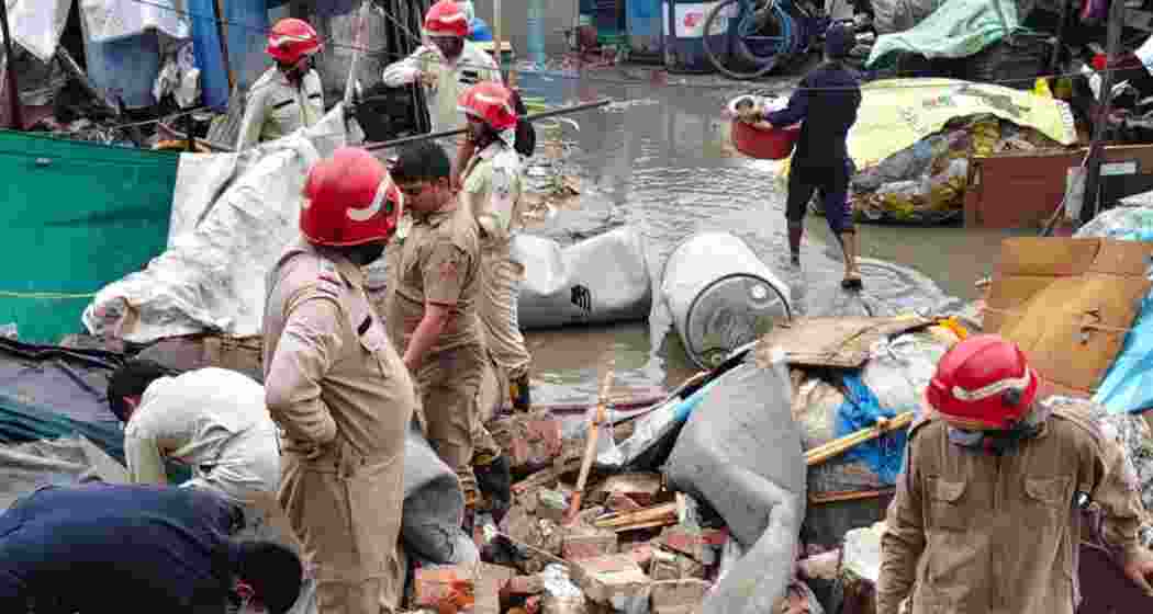 Rescue workers at the site of a deadly wall collapse in Delhi’s Hari Nagar.