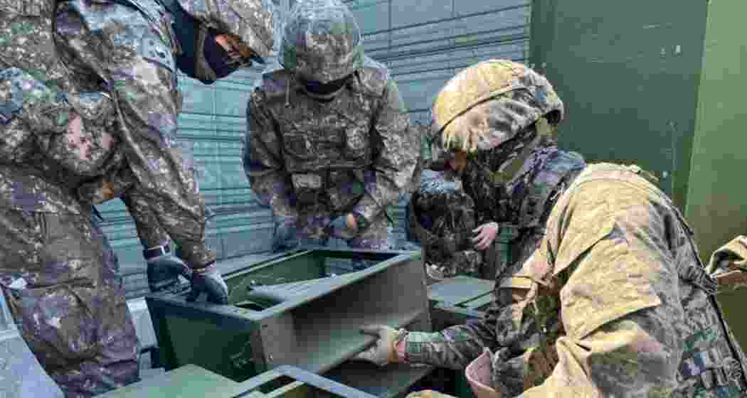 South Korean soldiers inspect loudspeaker equipment at an unspecified location near the inter-Korean border.