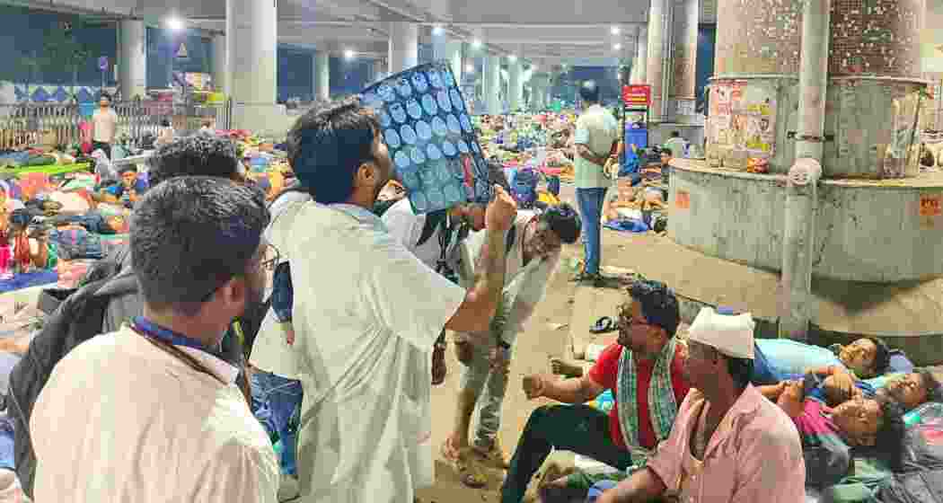 Police and medical personnel attend to injured teachers following a clash with police during a protest over the WBSSC recruitment scam outside Kolkata's Bikash Bhawan late on Thursday.