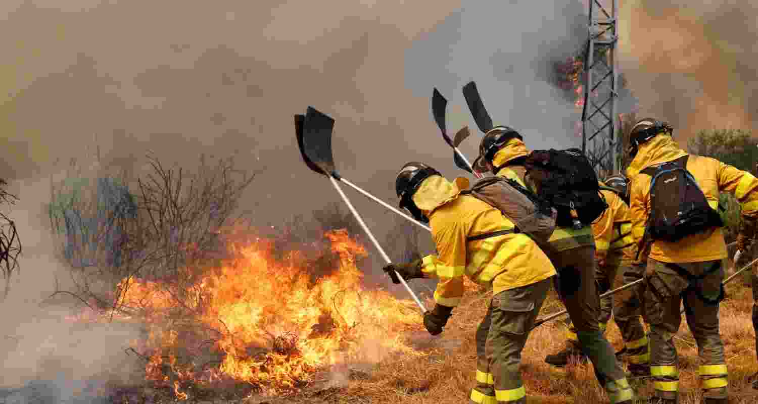 Firefighters battle a wildfire in Veiga das Meas, northwestern Spain.
