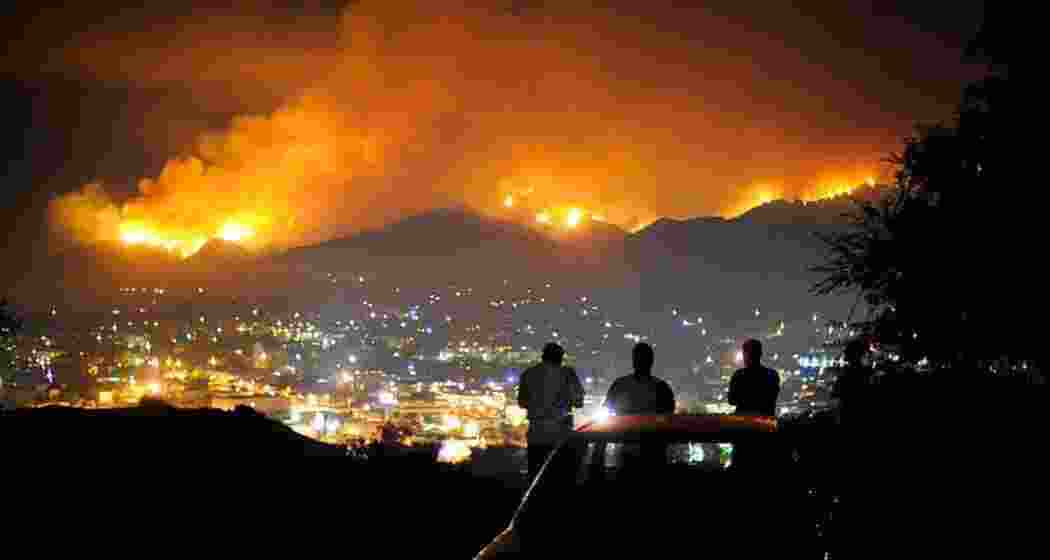 Onlookers watch from a distance as wildfires continue to ravage Los Angeles, leaving a trail of destruction with homes, vehicles, and neighbourhoods reduced to ash, leaving 11 dead and thousands displaced.