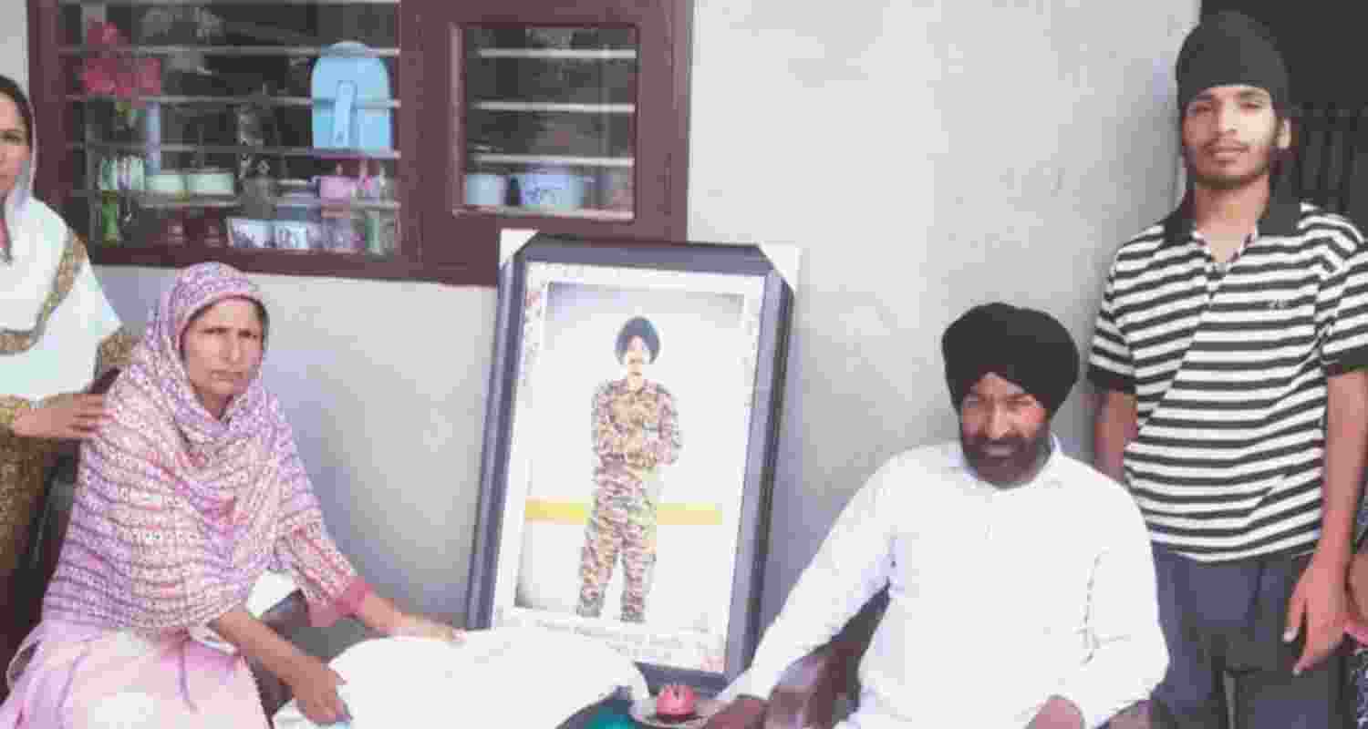Agniveer Akashdeep Singh's family sitting beside his ashes and a photograph at their residence at Kothe Chahal village in Faridkot district. Agniveer Akashdeep Singh's family sitting beside his ashes and a photograph at their residence at Kothe Chahal village in Faridkot district.