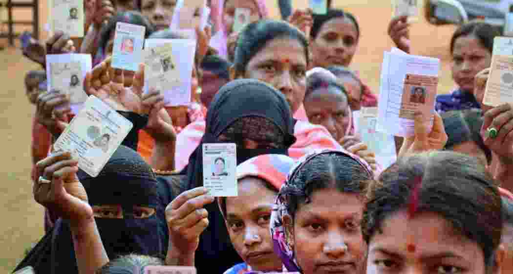 Voters stand in a queue at a polling station in Assam during the 2024 Lok Sabha elections, waiting to cast their ballots amid heavy turnout across the state. Voters stand in a queue at a polling station in Assam during the 2024 Lok Sabha elections, waiting to cast their ballots amid heavy turnout across the state.