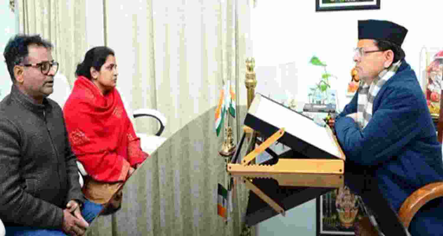 Chief Minister Pushkar Singh Dhami with wife and brother of late journalist Pankaj Mishra. Chief Minister Pushkar Singh Dhami with wife and brother of late journalist Pankaj Mishra.