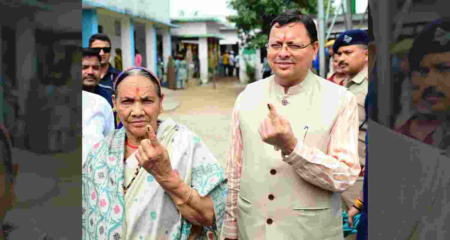 CM Pushkar Singh Dhami and his mother Bishna Devi caste vote for Panchayat elections in Khatima, Uttarakhand, on Thursday. CM Pushkar Singh Dhami and his mother Bishna Devi caste vote for Panchayat elections in Khatima, Uttarakhand, on Thursday.