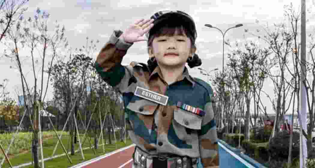 Child singing prodigy Esther Hnamte salutes in an Indian Army uniform. Child singing prodigy Esther Hnamte salutes in an Indian Army uniform.
