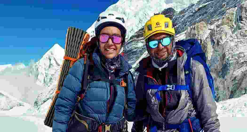 Kaamya Karthikeyan (left) and Commander S Karthikeyan celebrate their successful ascent of Mount Everest with a joyful pose. Kaamya Karthikeyan (left) and Commander S Karthikeyan celebrate their successful ascent of Mount Everest with a joyful pose.