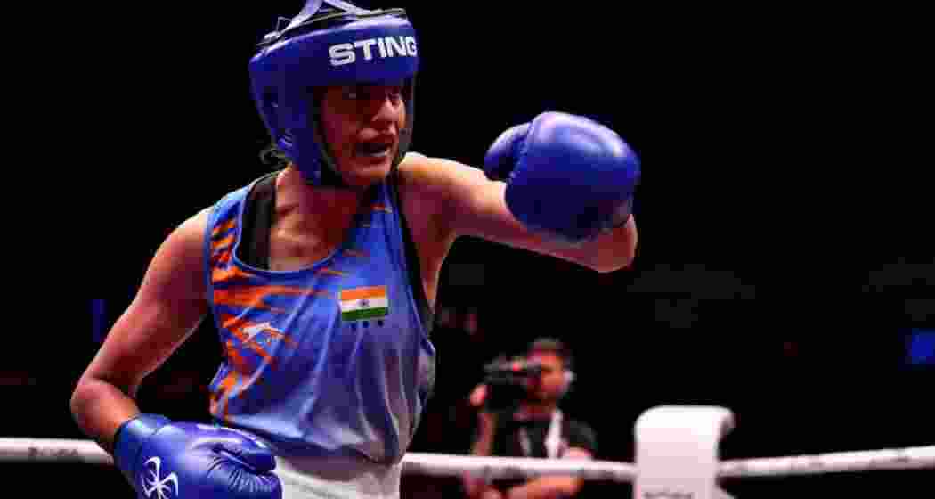 Indian boxer Jasmine Lamboria throws a punch during a bout. Indian boxer Jasmine Lamboria throws a punch during a bout.