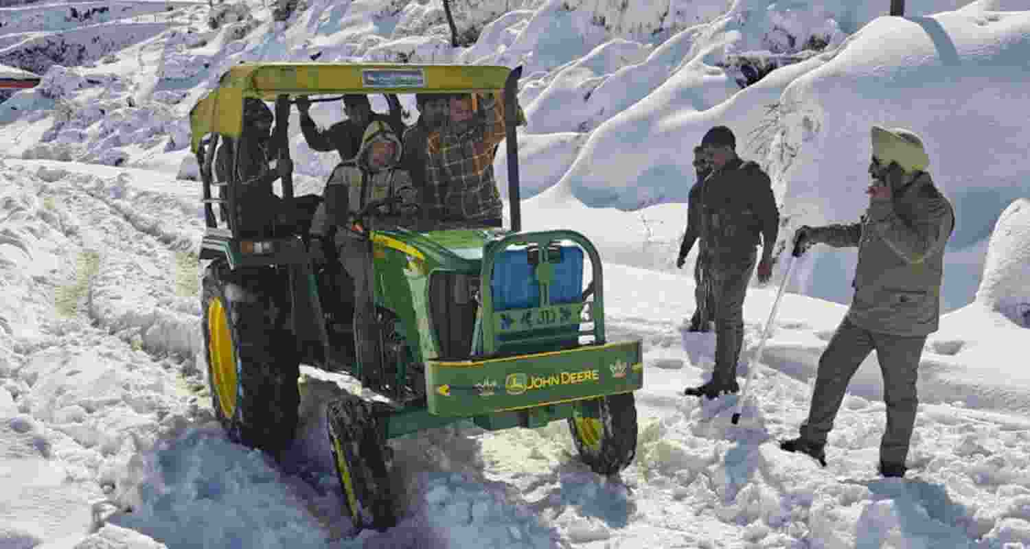 Security personnel inspect at a snow-covered path amid heavy snowfall in Kotranka area, Rajouri district, Jammu and Kashmir, Sunday. Security personnel inspect at a snow-covered path amid heavy snowfall in Kotranka area, Rajouri district, Jammu and Kashmir, Sunday.