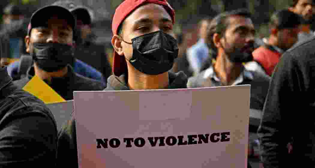 A demonstrator holds a placard during a protest in New Delhi on December 9, 2024, demanding restoration of peace in Manipur. A demonstrator holds a placard during a protest in New Delhi on December 9, 2024, demanding restoration of peace in Manipur.