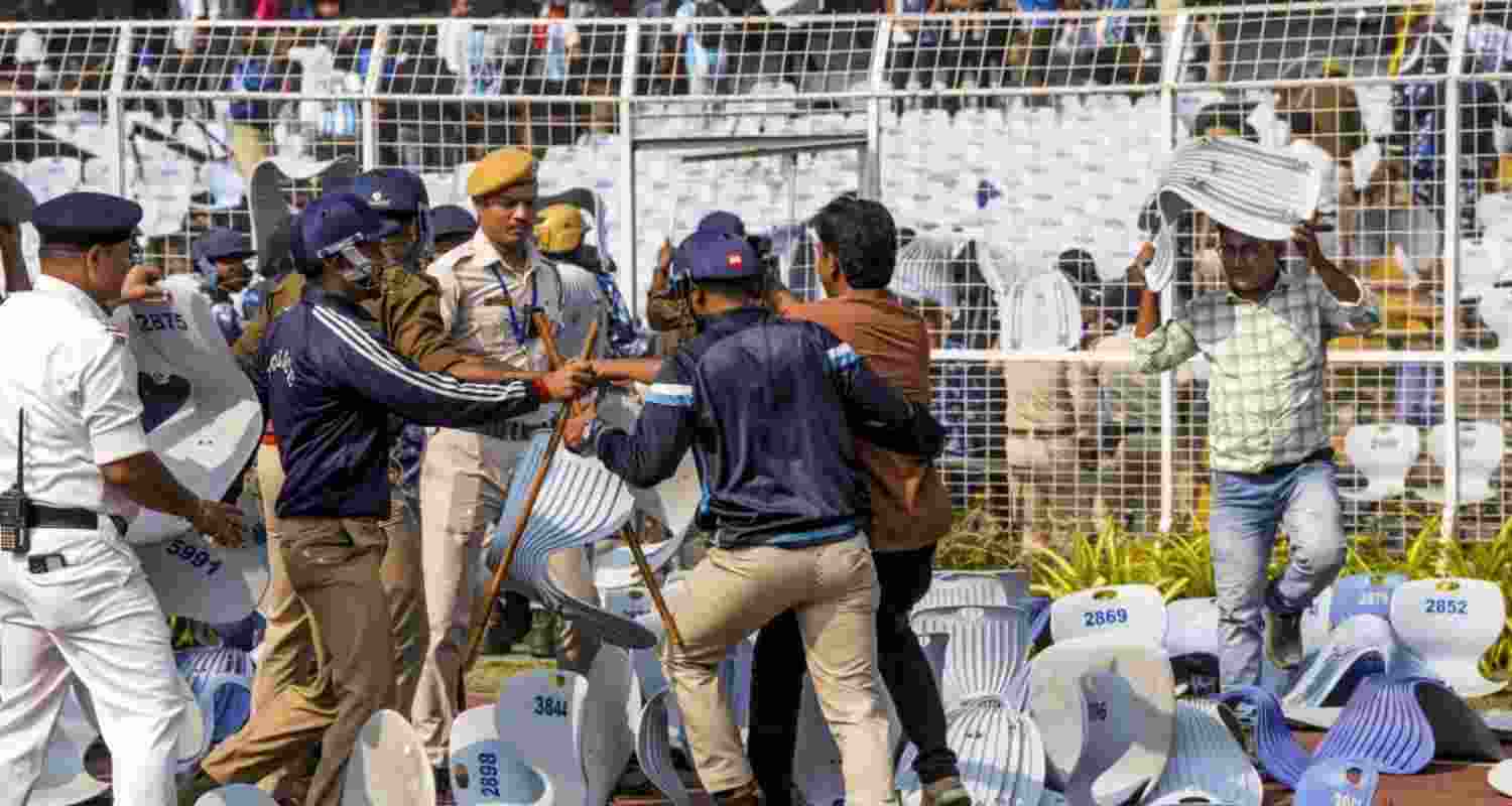 Security personnel try to stop a person amid chaos during an event of Argentine footballer Lionel Messi as part of his 'G.O.A.T. India Tour 2025', at Vivekananda Yuba Bharati Krirangan (VYBK), in Kolkata, Saturday. (File Photo) Security personnel try to stop a person amid chaos during an event of Argentine footballer Lionel Messi as part of his 'G.O.A.T. India Tour 2025', at Vivekananda Yuba Bharati Krirangan (VYBK), in Kolkata, Saturday. (File Photo)