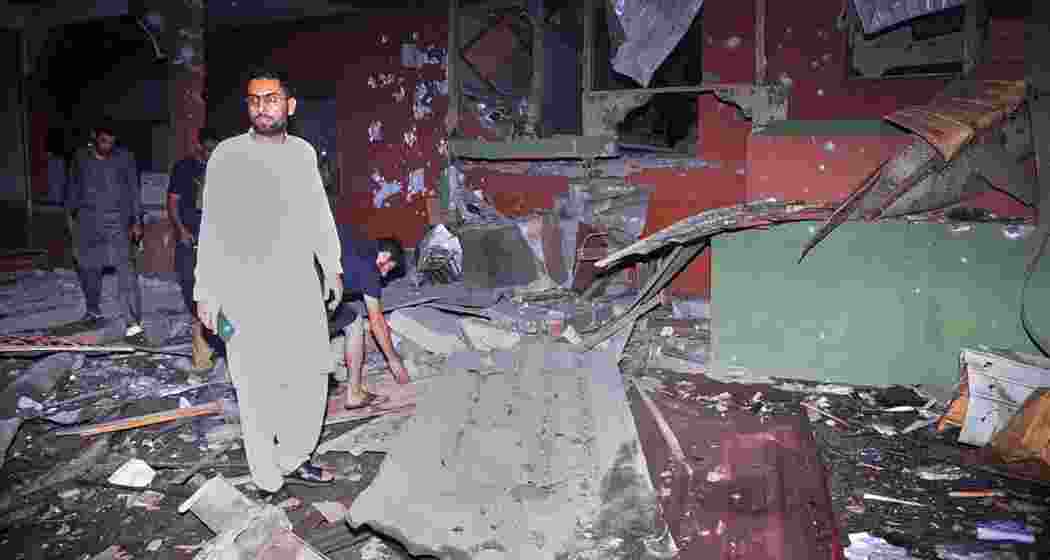 Local residents inspect a building damaged in a suspected Indian missile strike near Muzaffarabad, the capital of Pakistan-controlled Kashmir, on May 7, 2025, following heightened military tensions between India and Pakistan. Local residents inspect a building damaged in a suspected Indian missile strike near Muzaffarabad, the capital of Pakistan-controlled Kashmir, on May 7, 2025, following heightened military tensions between India and Pakistan.
