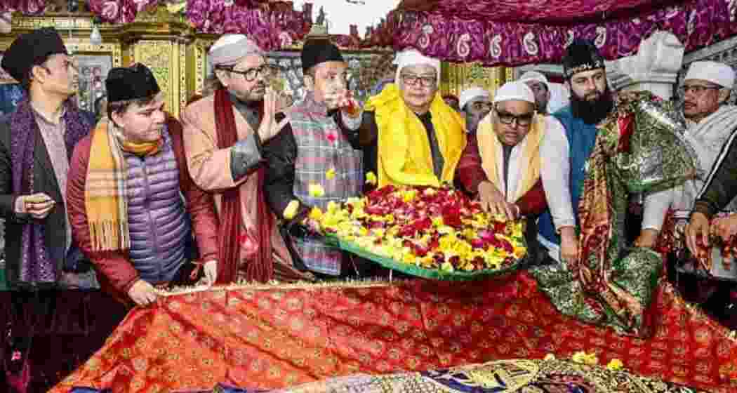 Union Minister for Minority Affairs Kiren Rijiju offers a ceremonial 'chadar' on behalf of Prime Minister Narendra Modi at the Hazrat Nizamuddin Dargah. Union Minister for Minority Affairs Kiren Rijiju offers a ceremonial 'chadar' on behalf of Prime Minister Narendra Modi at the Hazrat Nizamuddin Dargah.