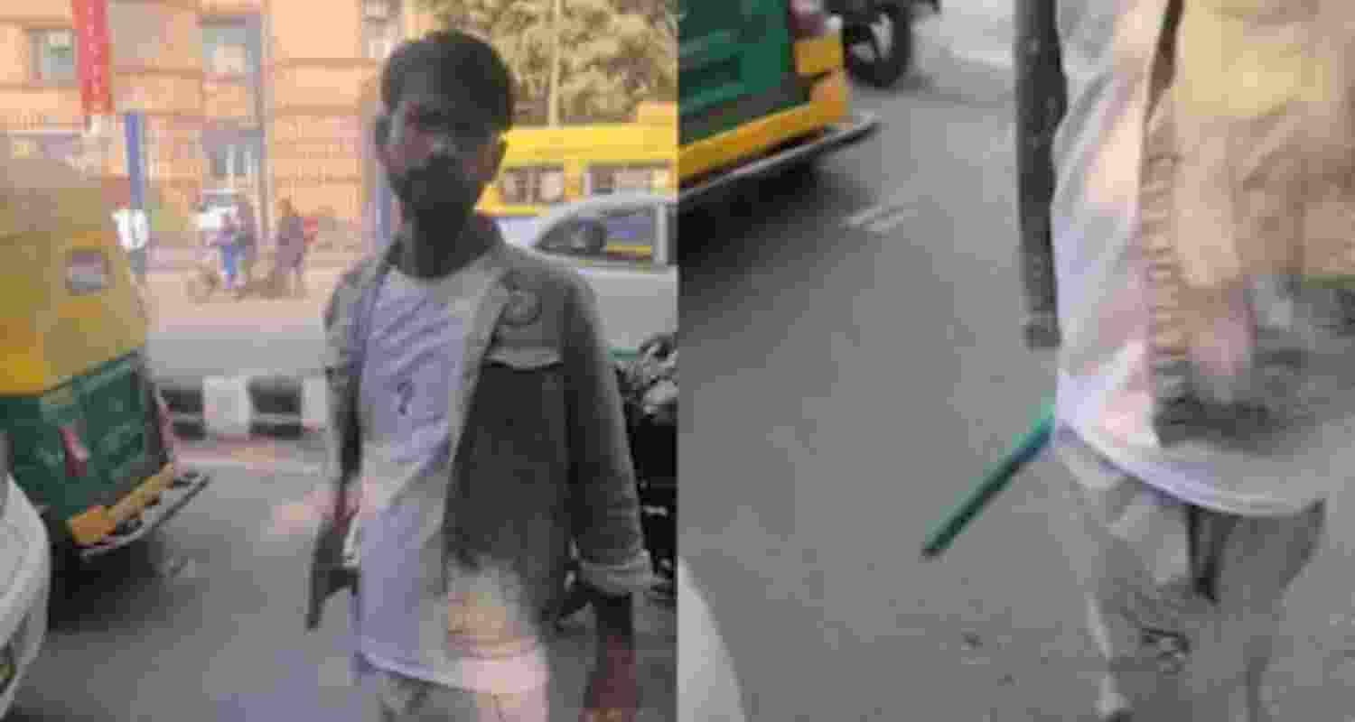 The accused Rapido driver is seen holding a rod in his hand. The accused Rapido driver is seen holding a rod in his hand.