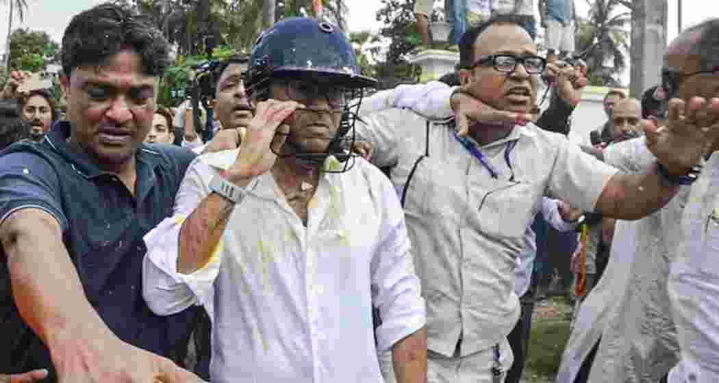TMC general secretary Abhishek Banerjee wears a helmet after stones, shoes and eggs were hurled at him during his visit to meet families of post-poll violence victims, in Sonarpur, West Bengal on Saturday. (PTI) TMC general secretary Abhishek Banerjee wears a helmet after stones, shoes and eggs were hurled at him during his visit to meet families of post-poll violence victims, in Sonarpur, West Bengal on Saturday. (PTI)