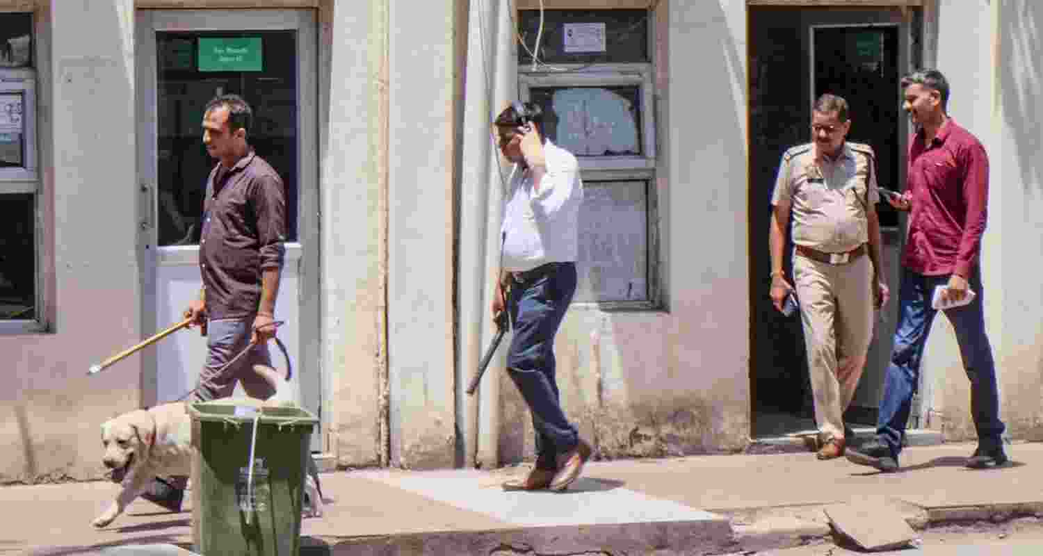 Bomb Disposal Squad (BDS) members inspect the Gurugram Municipal Corporation Office after it received a bomb threat via email - file image. Bomb Disposal Squad (BDS) members inspect the Gurugram Municipal Corporation Office after it received a bomb threat via email - file image.