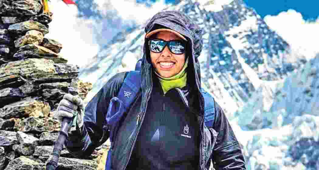 Nisha Shasikumar smiles atop Mount Everest after becoming the youngest person to scale the world's highest peak from the south route. Nisha Shasikumar smiles atop Mount Everest after becoming the youngest person to scale the world's highest peak from the south route.