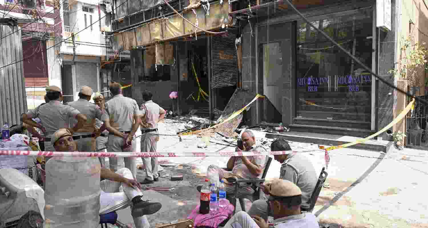 Police personnel keep a vigil at the spot a day after a fire at the Flourish Stay B&B killed at least 21 people, including 12 foreigners, at Hauz Rani area of Malviya Nagar, in New Delhi, Thursday, June 4, 2026. Police personnel keep a vigil at the spot a day after a fire at the Flourish Stay B&B killed at least 21 people, including 12 foreigners, at Hauz Rani area of Malviya Nagar, in New Delhi, Thursday, June 4, 2026.