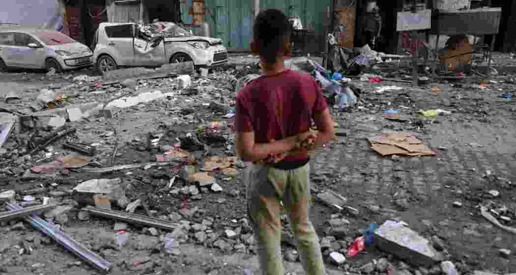A Palestinian boy looking at the rubble in the aftermath of an Israeli strike in Gaza City. A Palestinian boy looking at the rubble in the aftermath of an Israeli strike in Gaza City.