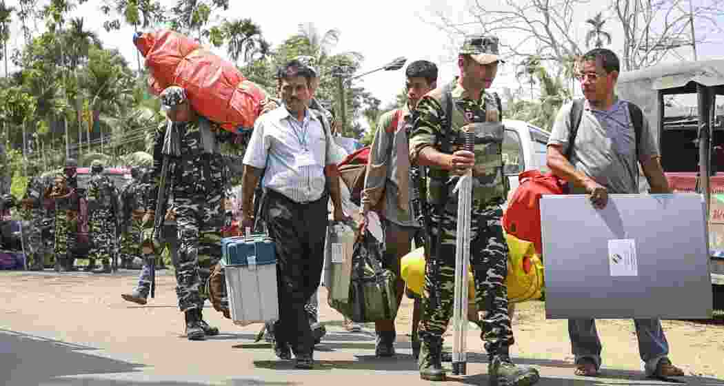 Polling officials along with security personnel carrying EVMs, VVPAT and other election material depart from a distribution centre, to polling booths on the eve of Bye-election for the 56-AC Dharmanagar assembly seat, in North Tripura district, on Wednesday. Polling officials along with security personnel carrying EVMs, VVPAT and other election material depart from a distribution centre, to polling booths on the eve of Bye-election for the 56-AC Dharmanagar assembly seat, in North Tripura district, on Wednesday.