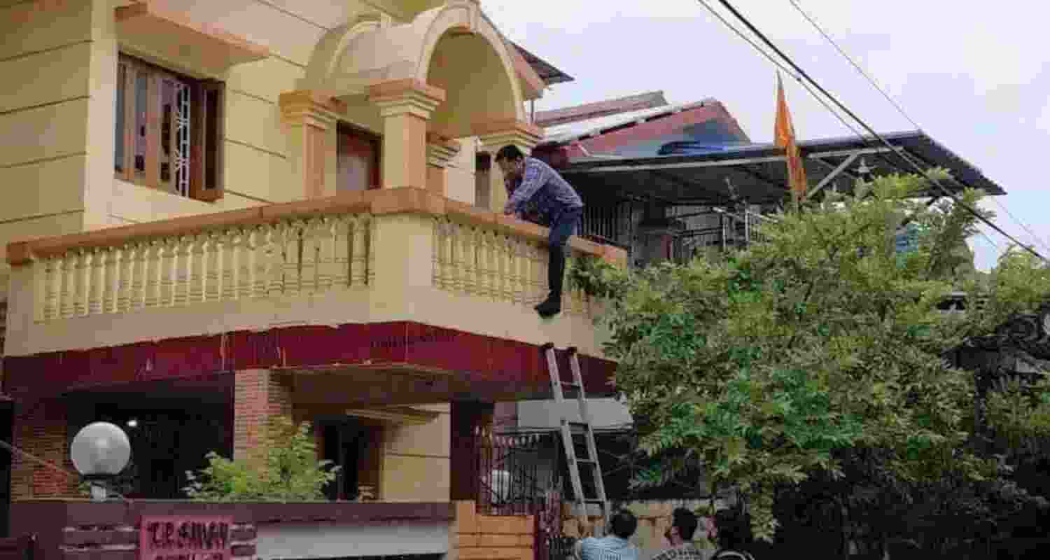 ED sleuths try to enter a house in Dhanbad during a raid in connection with illegal coal mining on Tuesday. ED sleuths try to enter a house in Dhanbad during a raid in connection with illegal coal mining on Tuesday.