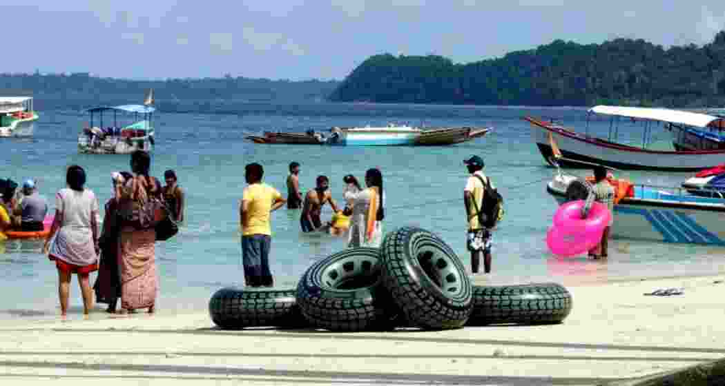 Tourists enjoying the sea waves at Elephant Beach, in the Andaman and Nicobar Islands. Tourists enjoying the sea waves at Elephant Beach, in the Andaman and Nicobar Islands.