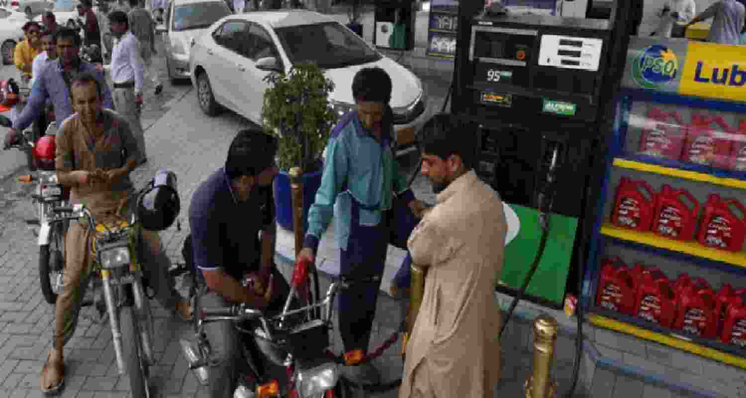 A file photograph of commuters queued up at a petrol pump in Pakistan. A file photograph of commuters queued up at a petrol pump in Pakistan.
