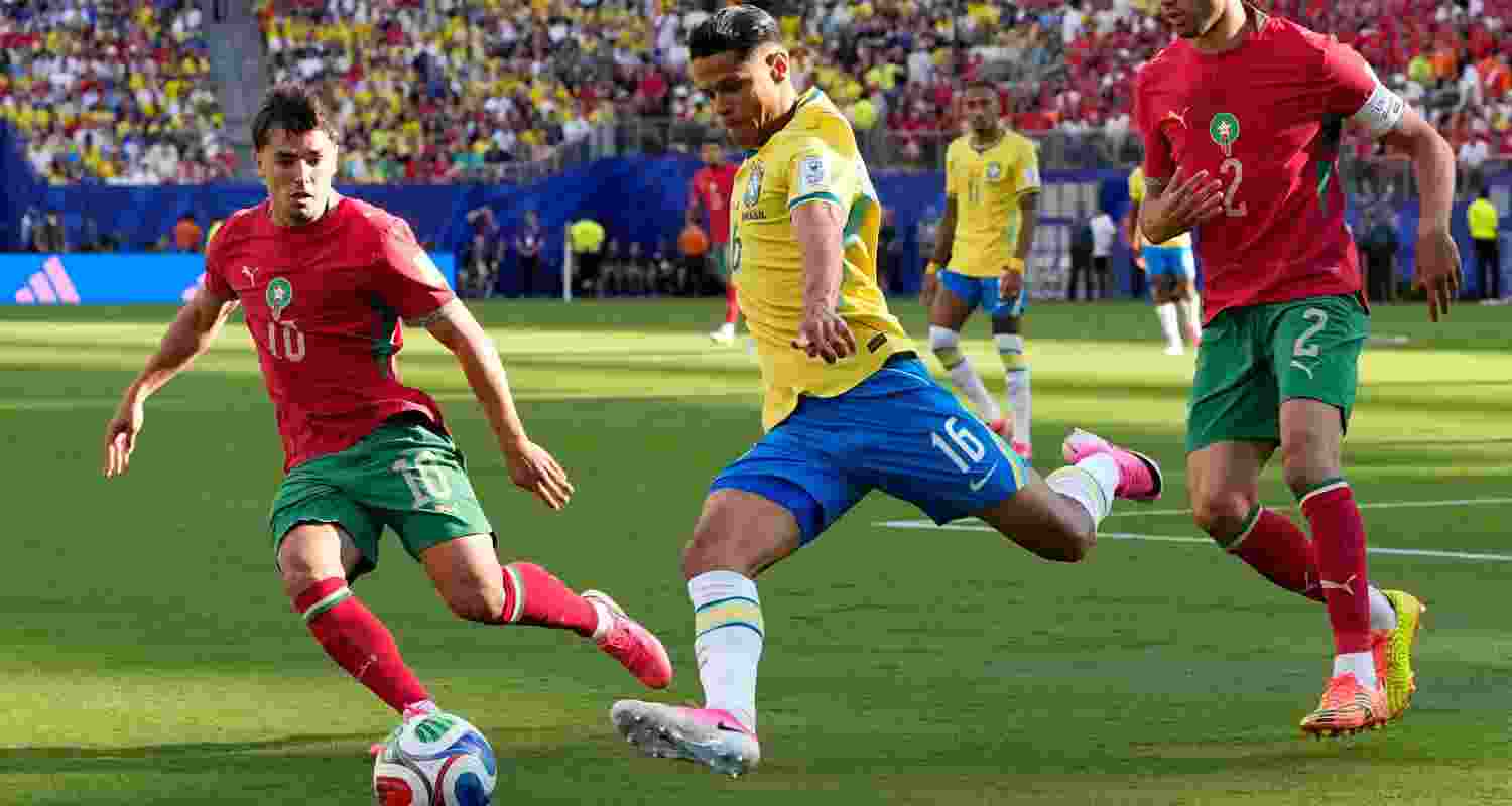 Brazil's Douglas Santos, center, and Morocco's Brahim Diaz battle for the ball during the World Cup Group C soccer match in East Rutherford, N.J., near New York, Saturday, June 13, 2026. Brazil's Douglas Santos, center, and Morocco's Brahim Diaz battle for the ball during the World Cup Group C soccer match in East Rutherford, N.J., near New York, Saturday, June 13, 2026.