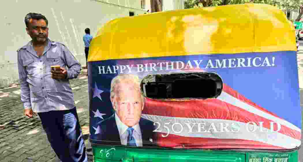 An auto-rickshaw carrying Donald Trump’s portrait and “Happy Birthday America!” slogan moves through New Delhi as part of a US Embassy promotional campaign. An auto-rickshaw carrying Donald Trump’s portrait and “Happy Birthday America!” slogan moves through New Delhi as part of a US Embassy promotional campaign.