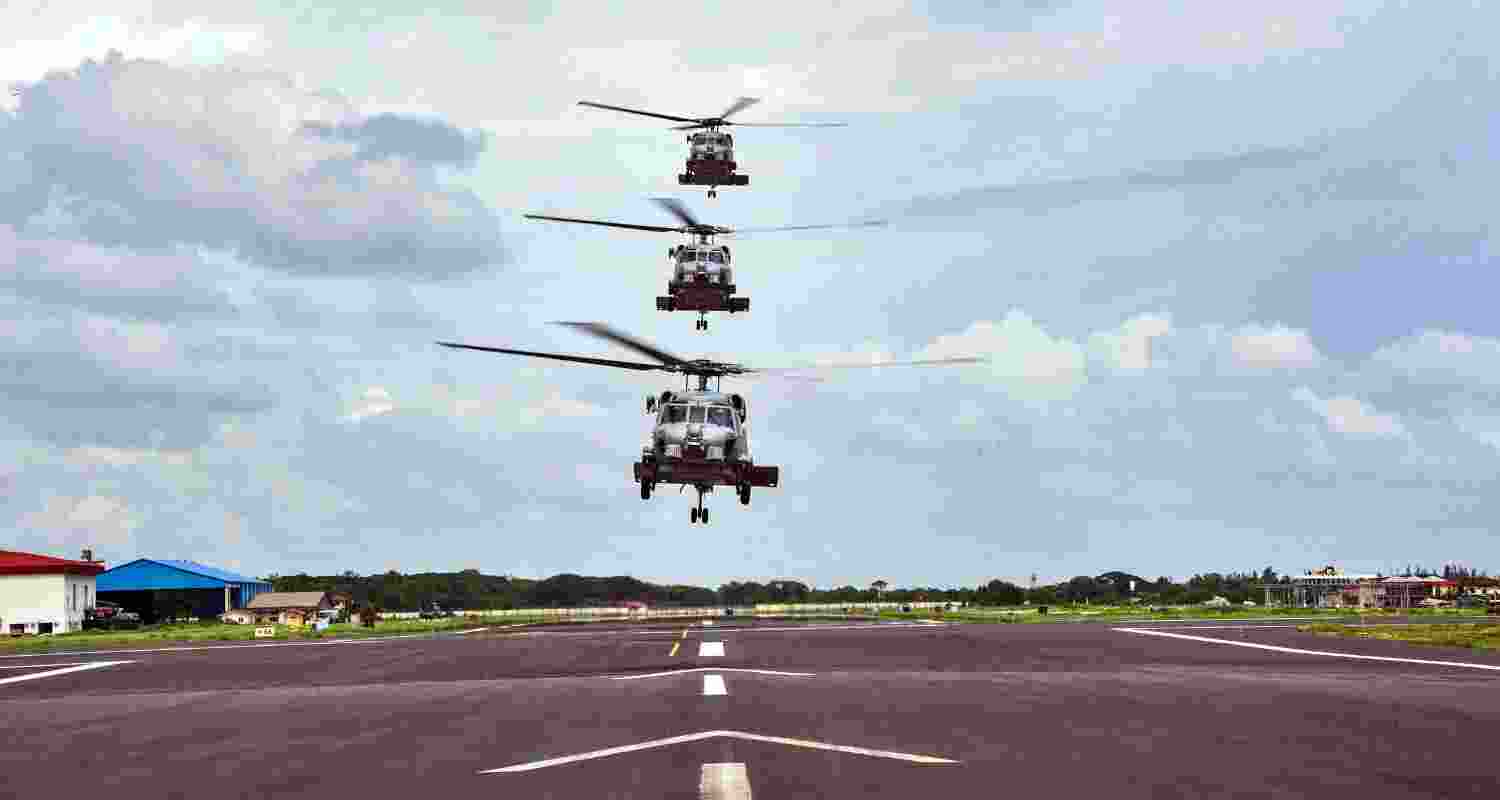Three MH-60R Seahawk helicopters in a vertical formation above the runway at INS Garuda, signifying their imminent induction into the Indian Navy's air squadron. Three MH-60R Seahawk helicopters in a vertical formation above the runway at INS Garuda, signifying their imminent induction into the Indian Navy's air squadron.