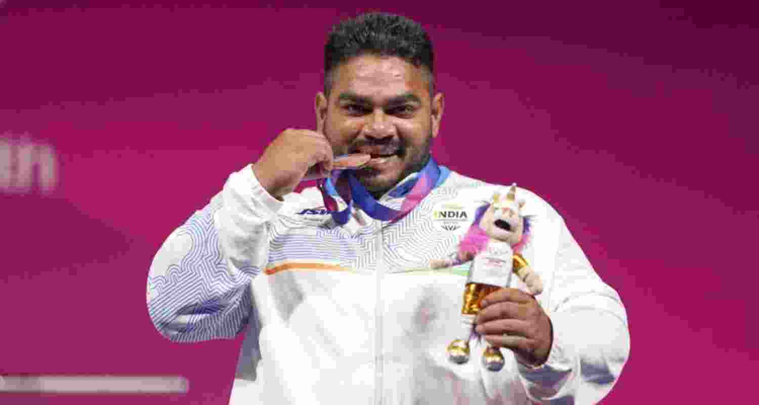 Jhandu Kumar celebrates after winning the bronze medal during the medal ceremony for the men’s heavyweight para powerlifting event at the Commonwealth Games in Glasgow. Jhandu Kumar celebrates after winning the bronze medal during the medal ceremony for the men’s heavyweight para powerlifting event at the Commonwealth Games in Glasgow.