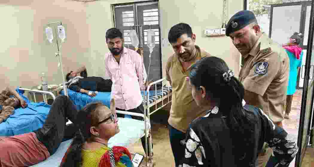 Relatives of patients speak to each other at a hospital in Bhavnagar following the suspected spurious liquor incident. Relatives of patients speak to each other at a hospital in Bhavnagar following the suspected spurious liquor incident.