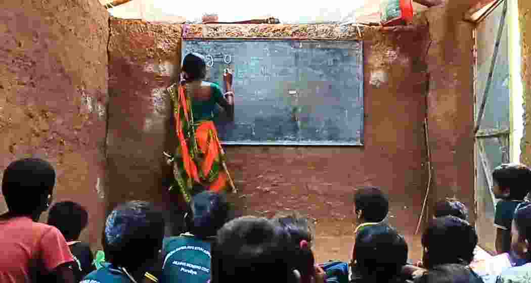 Malati Murmu conducts a class in Jiling Seren village as children learn seated on the mud floor. Malati Murmu conducts a class in Jiling Seren village as children learn seated on the mud floor.