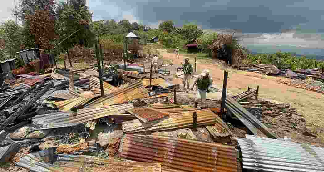 Police inspect burnt houses in Manipur’s Kamjong district after armed militants attacked border villages, forcing residents to flee into nearby forests Police inspect burnt houses in Manipur’s Kamjong district after armed militants attacked border villages, forcing residents to flee into nearby forests