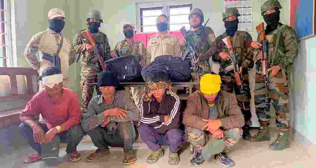 Security personnel with the arrested accused suspected to contain heroin during joint operations in Manipur’s Churachandpur district on Wednesday. Security personnel with the arrested accused suspected to contain heroin during joint operations in Manipur’s Churachandpur district on Wednesday.