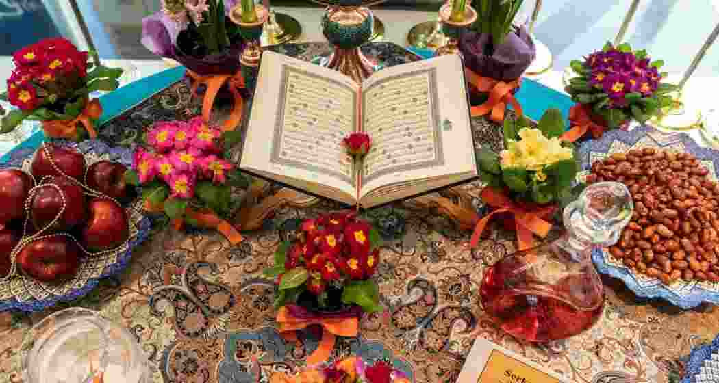 A beautifully arranged Haft-Sīn table symbolising renewal and prosperity for Nowruz, featuring seven traditional items representing health, wealth, love, and rebirth, as families gather to welcome the Persian New Year. A beautifully arranged Haft-Sīn table symbolising renewal and prosperity for Nowruz, featuring seven traditional items representing health, wealth, love, and rebirth, as families gather to welcome the Persian New Year.