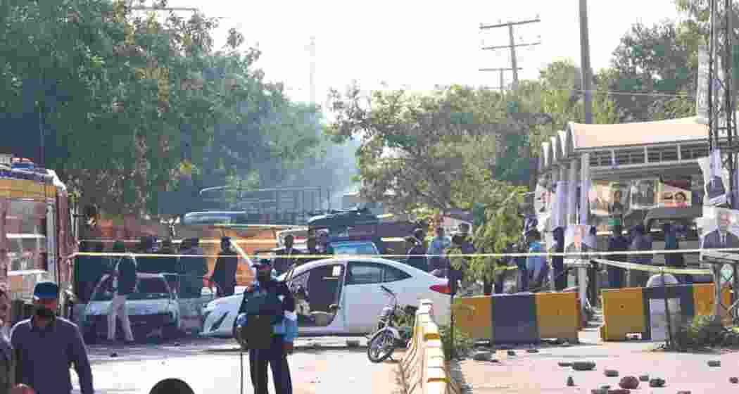 Security personnel gather near the site of twin roadside explosions in Bannu district, Pakistan, where seven people were killed and three others were injured. Security personnel gather near the site of twin roadside explosions in Bannu district, Pakistan, where seven people were killed and three others were injured.